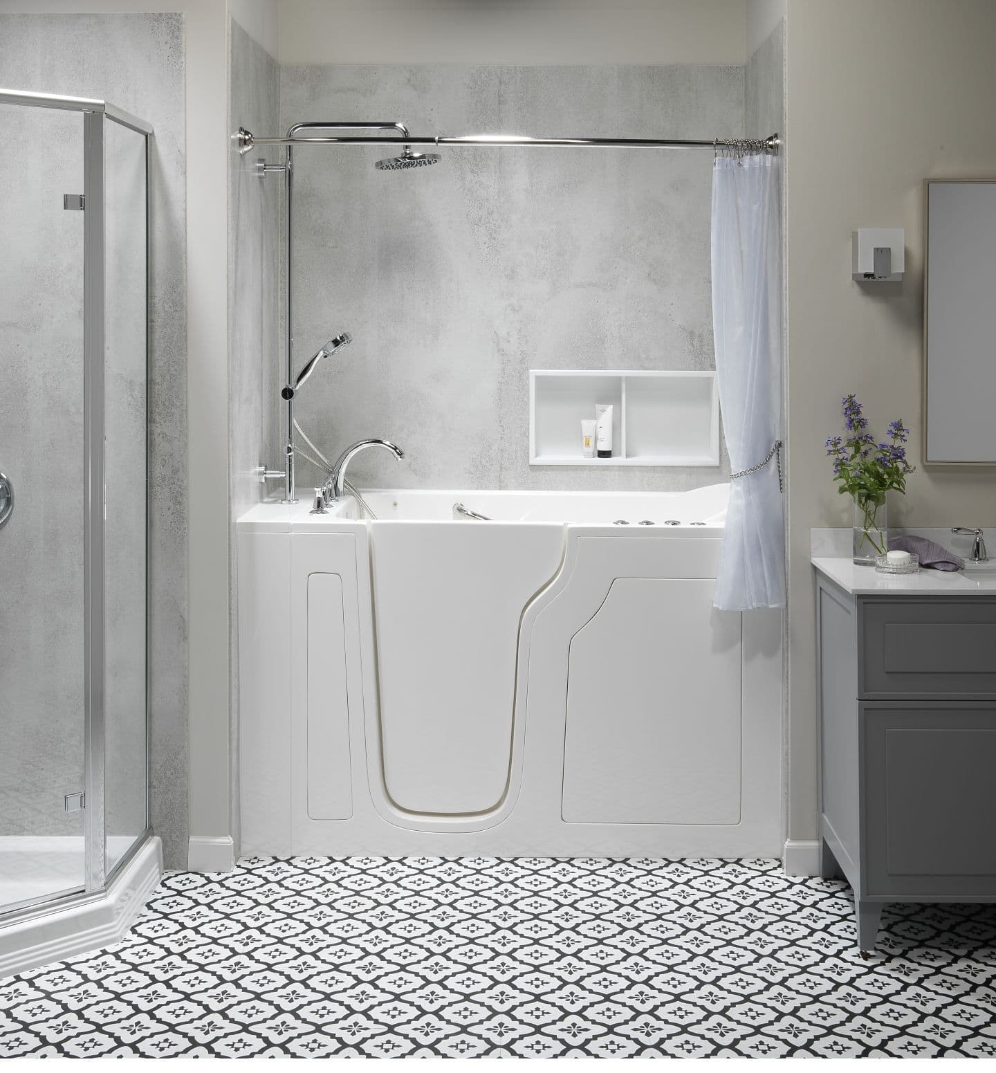 An accessible combination walk-in bathtub and shower with a curtain in an off-white bathroom with white tiled floor