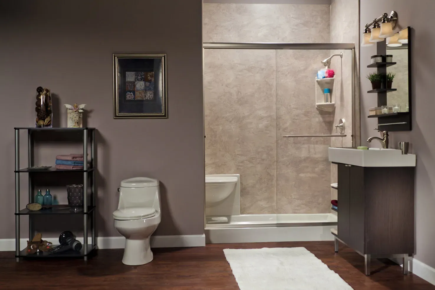 A mauve bathroom with a walk-in shower with built-in bench seating and sliding glass doors.