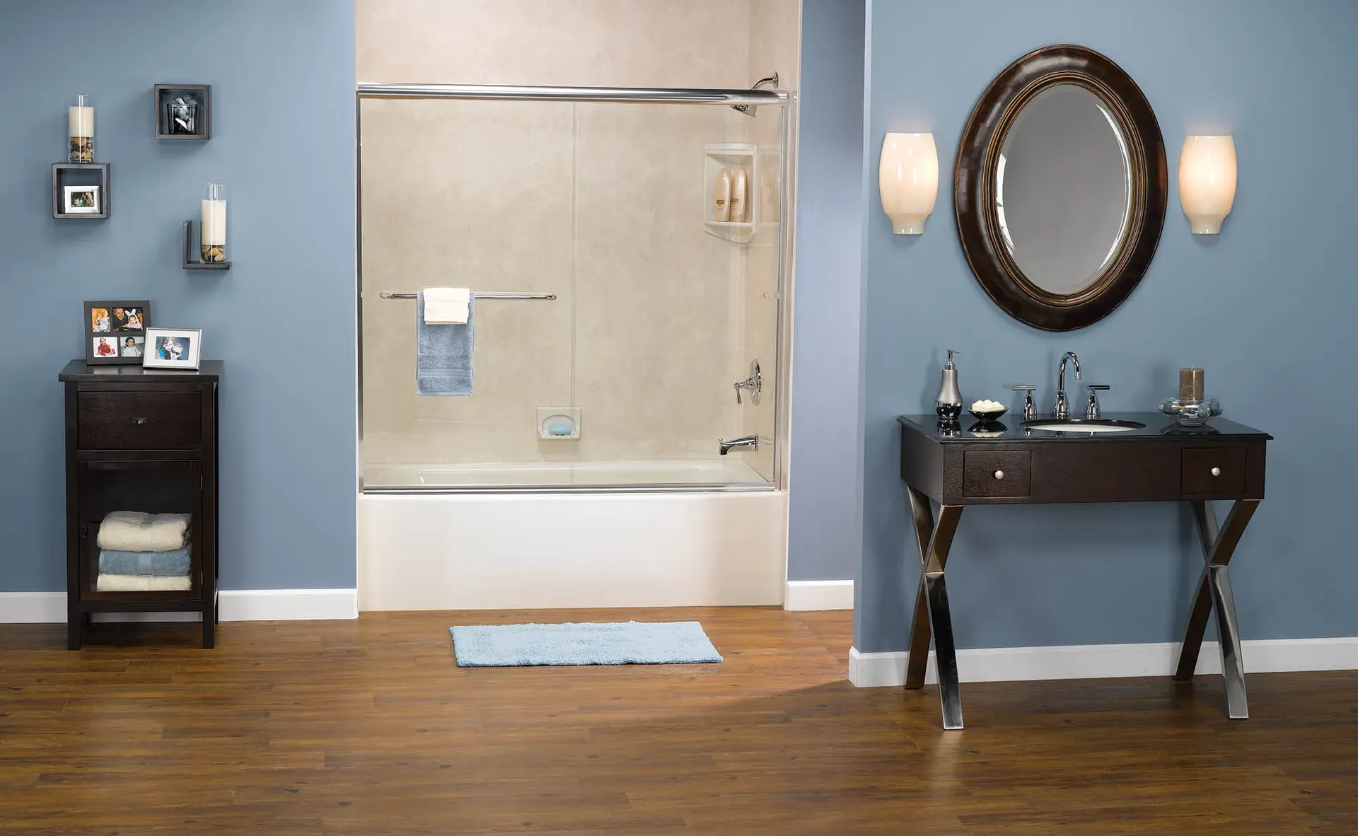 A blue bathroom with a combination shower bathtub with sliding glass doors and off-white shower walls.