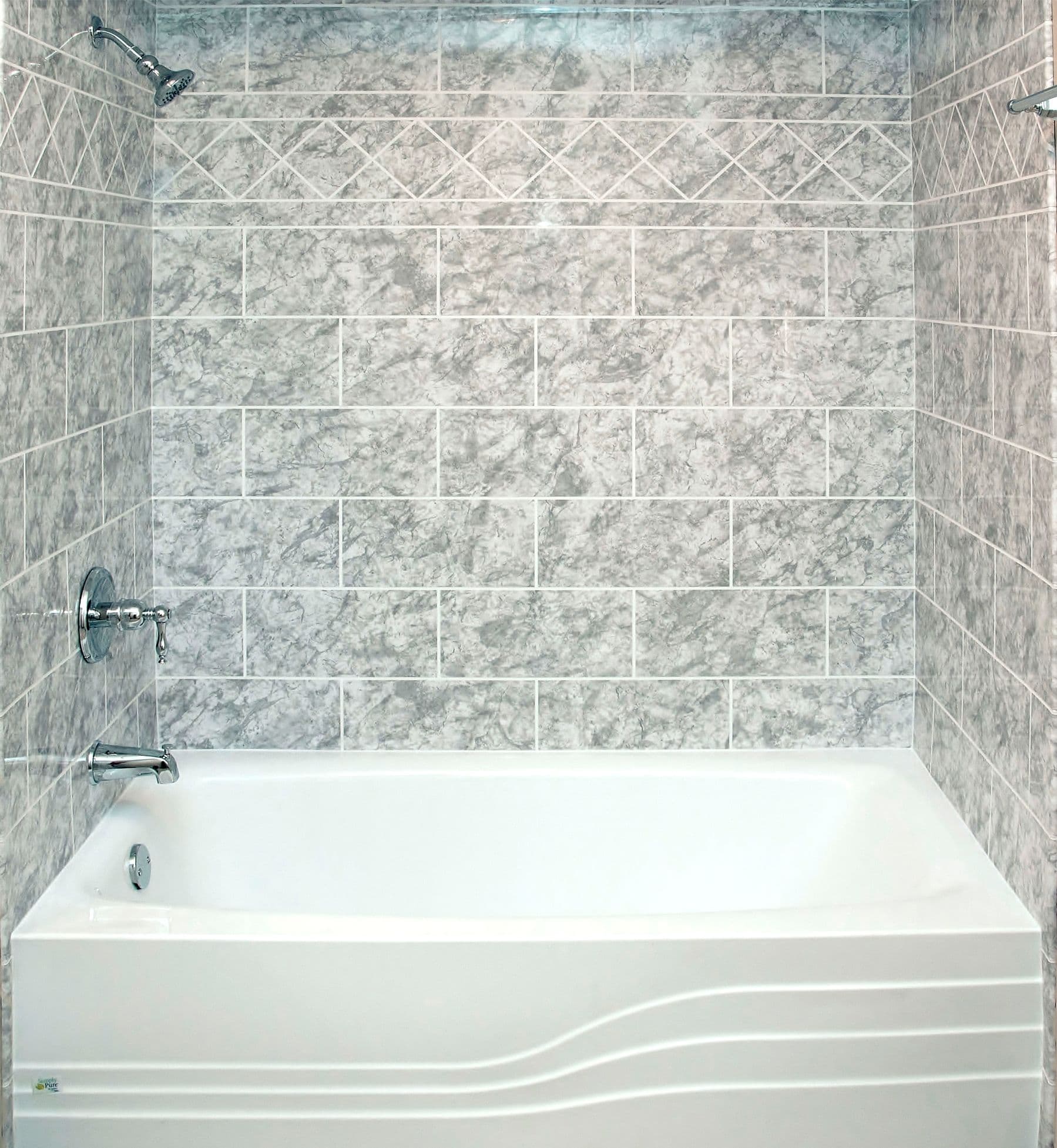 A white combination shower bathtub in a gray marble tiled shower.