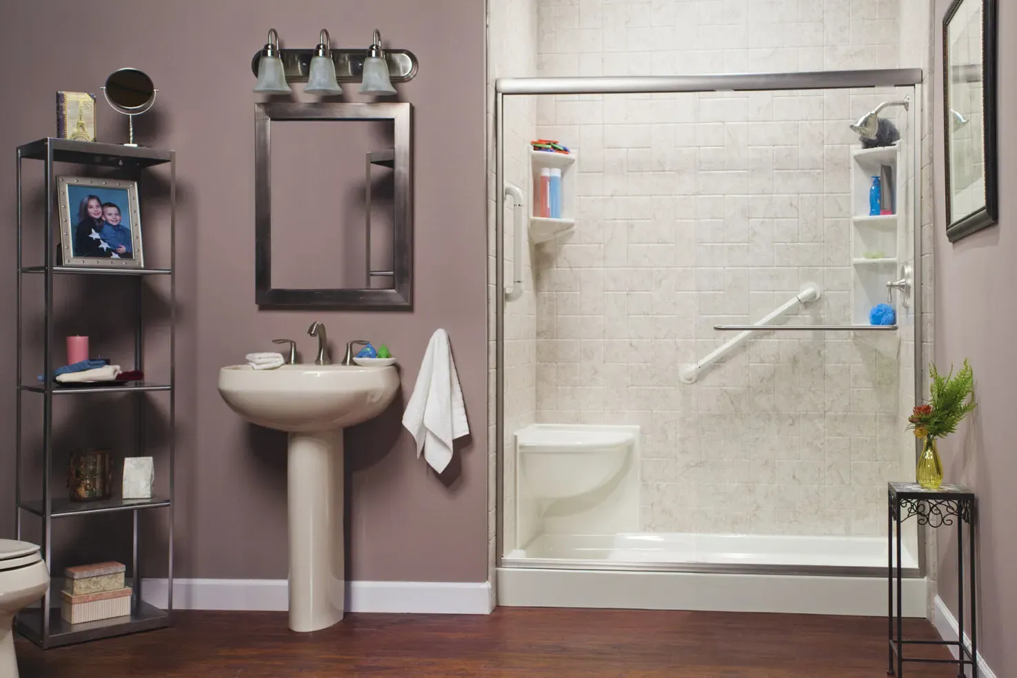 A mauve bathroom with a walk-in shower with built-in bench seating, grab bar, textured tile walls, and sliding glass doors.