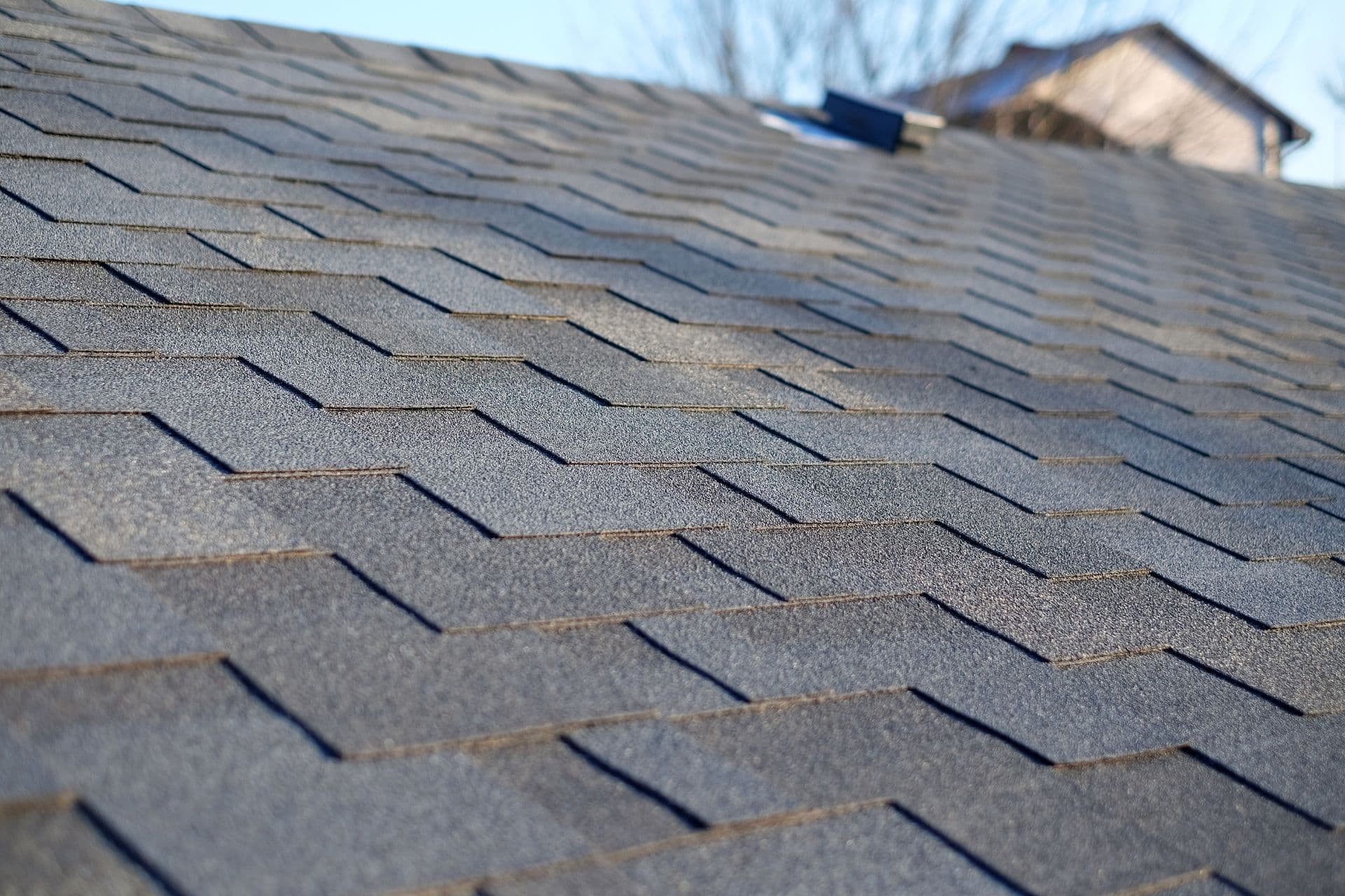 A close-up of gray roofing shingles.