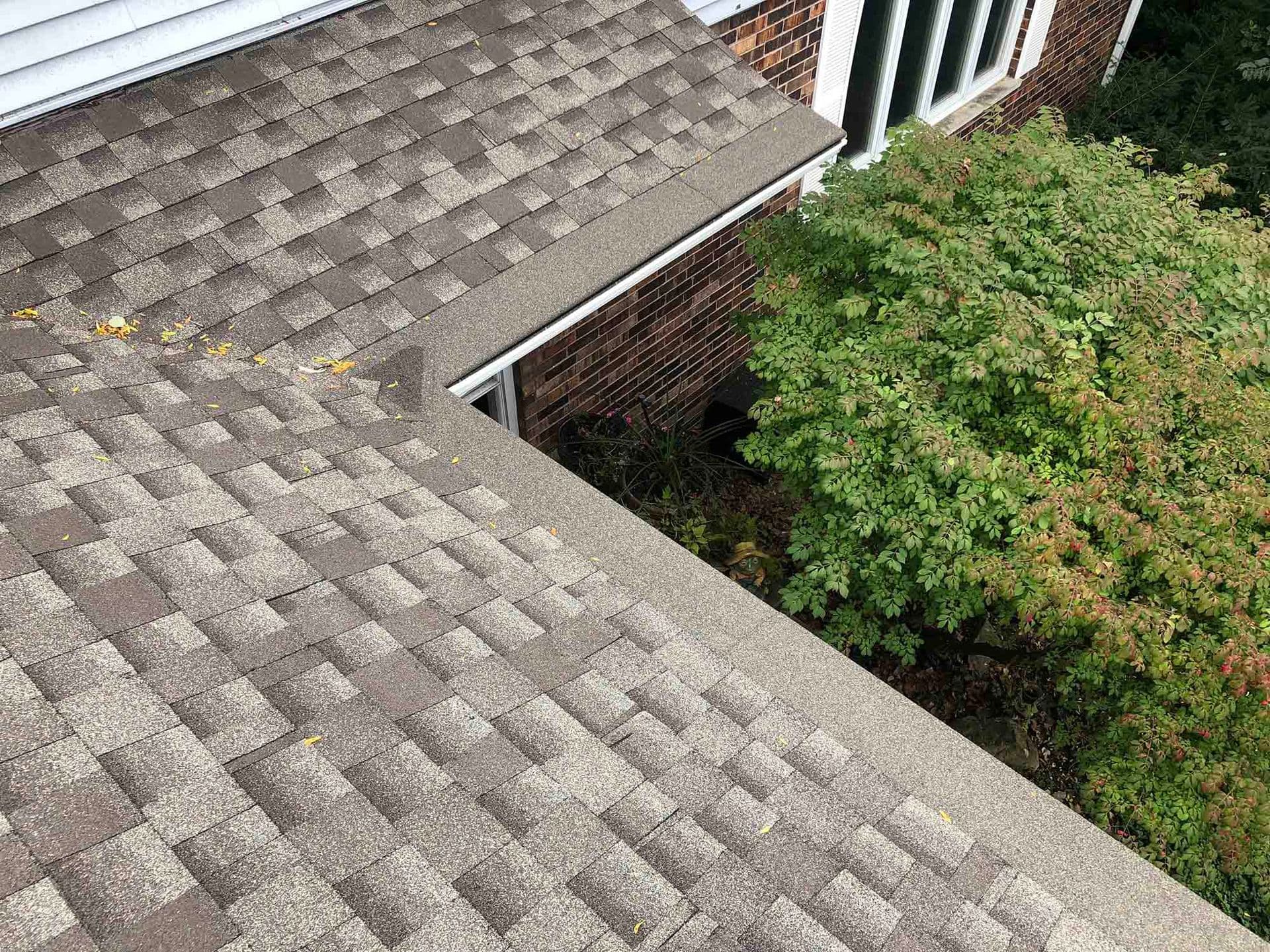 An overhead view of a house with gray roof and new gray Gutter Helmet gutter covers.