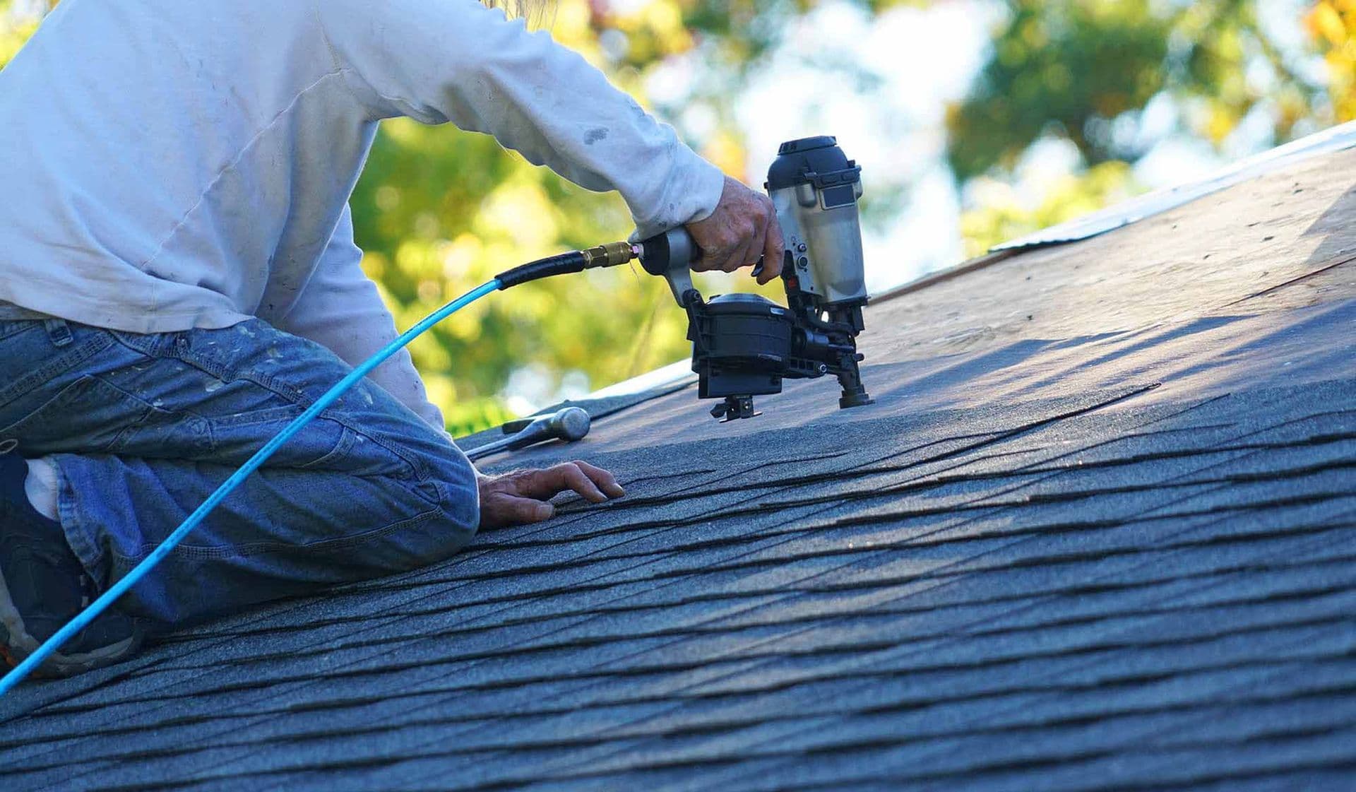 A worker installs new roofing.