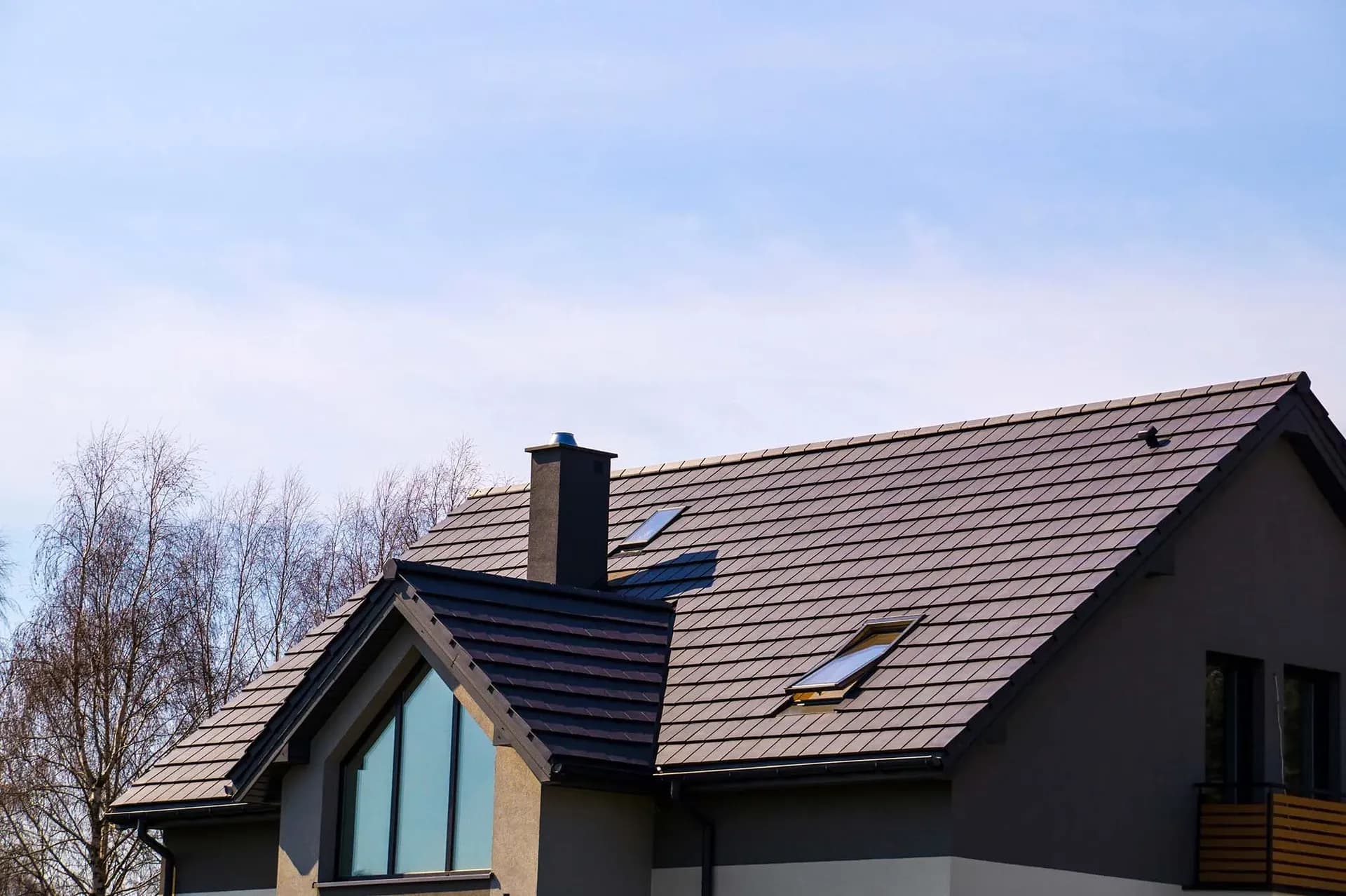A brown tile roof on a brown house.