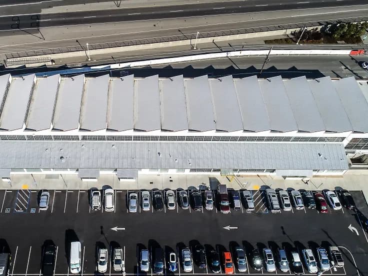 An overhead aerial view of a commercial building with new roofing.